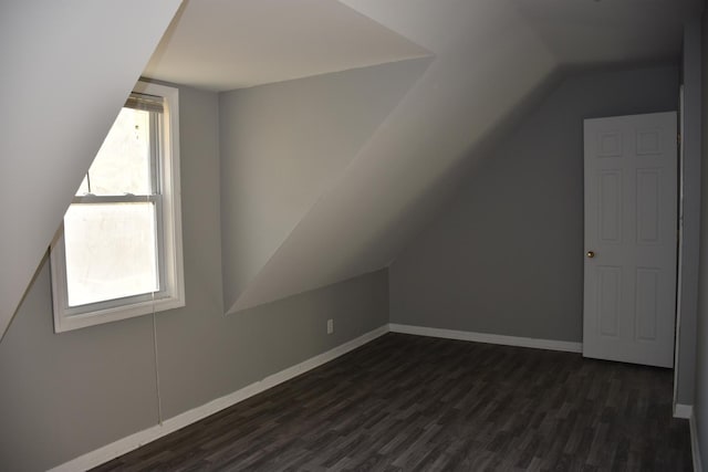 bonus room featuring vaulted ceiling and dark hardwood / wood-style floors