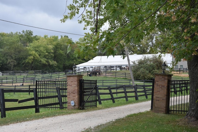 view of gate featuring a rural view and a yard