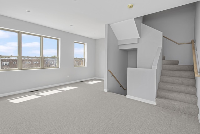 unfurnished living room with light colored carpet