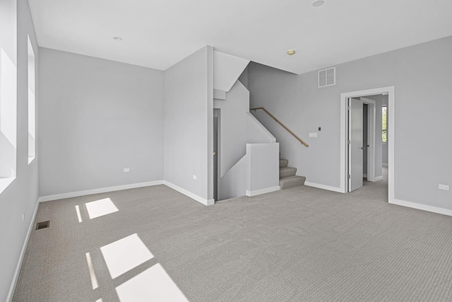 unfurnished living room featuring light carpet