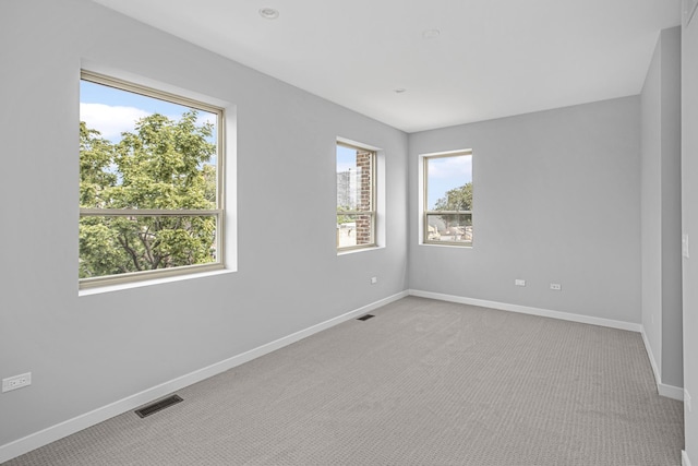 empty room featuring light colored carpet