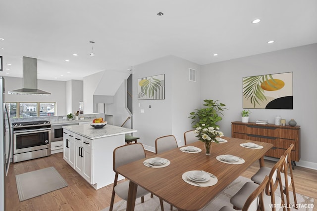 dining space with light hardwood / wood-style flooring