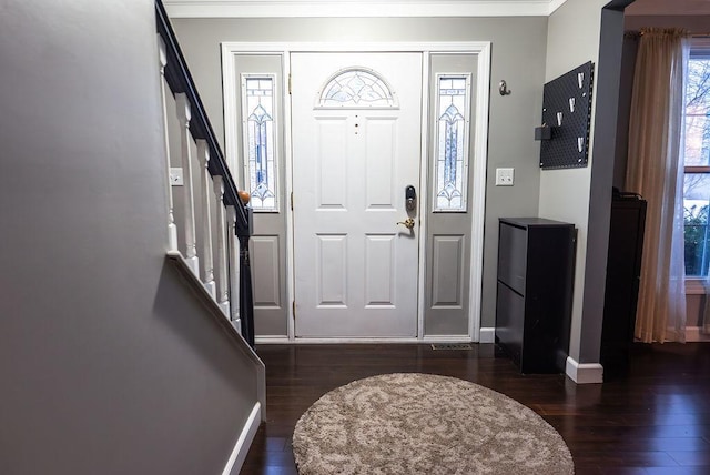 entrance foyer featuring dark hardwood / wood-style flooring and ornamental molding