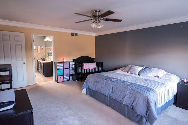 bedroom with ornamental molding, light carpet, and ensuite bath