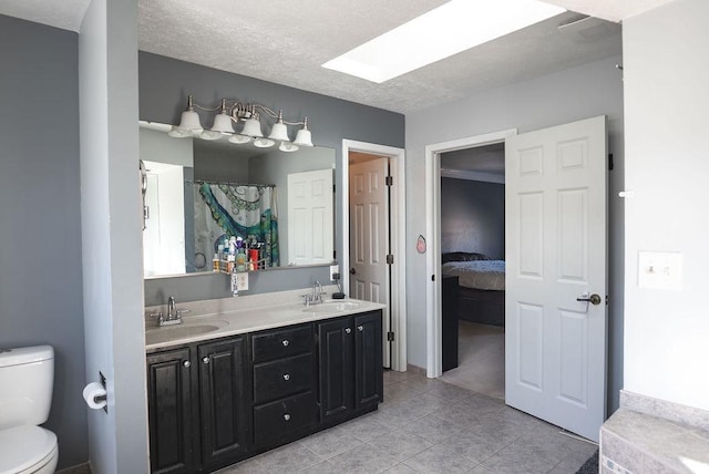 bathroom with walk in shower, tile patterned floors, toilet, a textured ceiling, and vanity