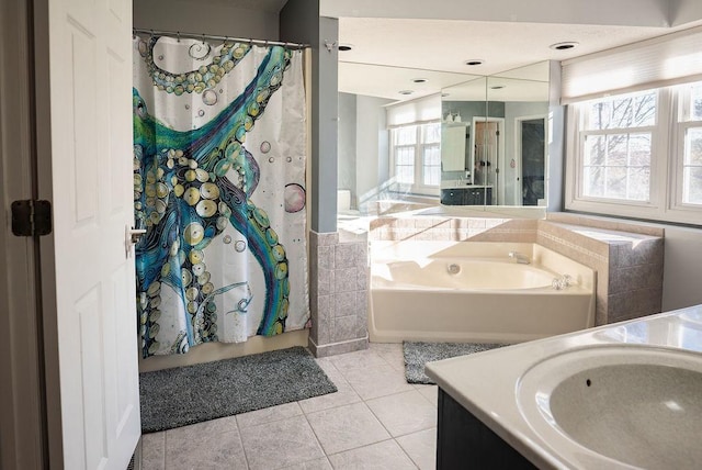 bathroom featuring tile patterned floors, a bathtub, and vanity