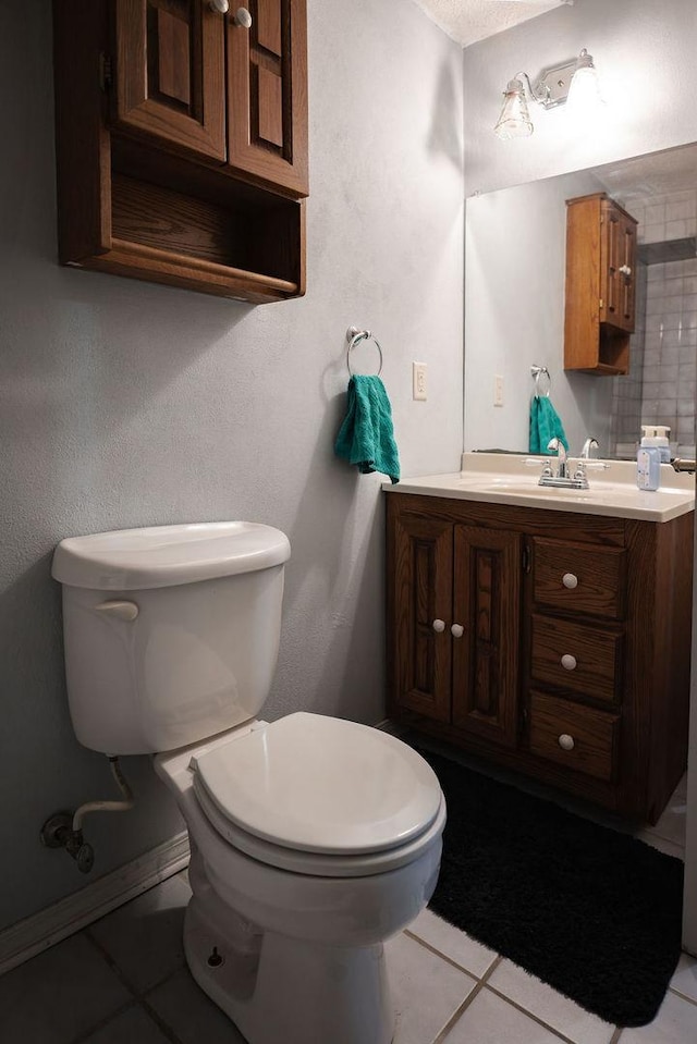 bathroom featuring tile patterned floors, vanity, and toilet