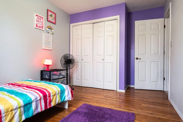 bedroom featuring hardwood / wood-style flooring, a closet, and a textured ceiling