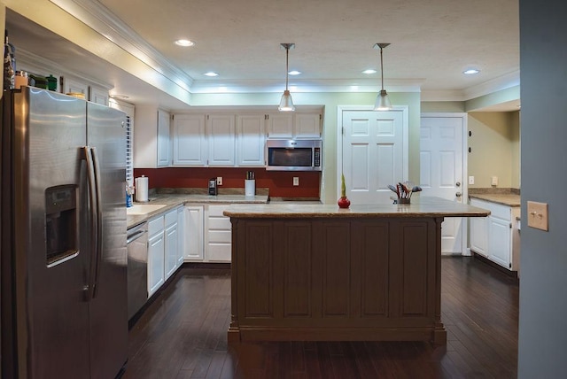 kitchen featuring white cabinets, dark hardwood / wood-style flooring, hanging light fixtures, a center island, and stainless steel appliances