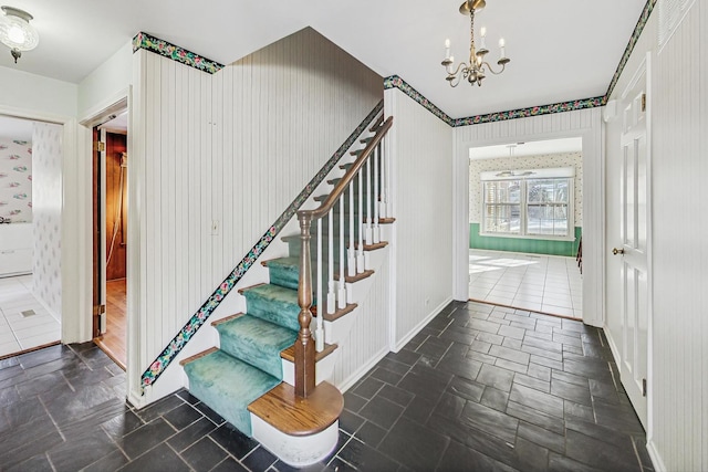 foyer entrance featuring an inviting chandelier