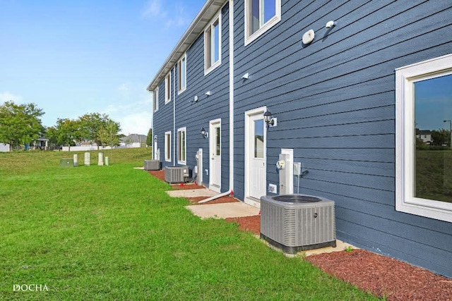 view of home's exterior featuring central AC and a yard