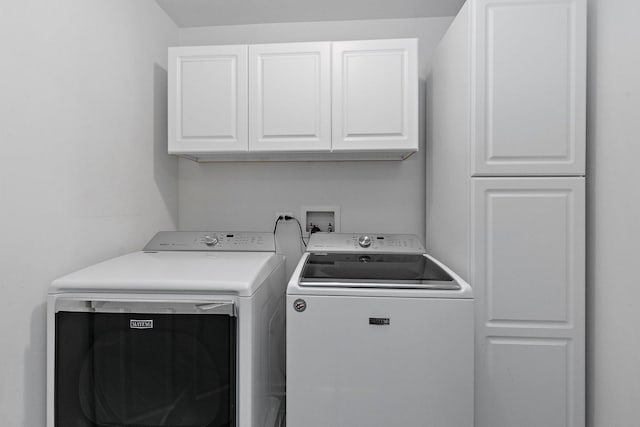 laundry area with cabinets and washing machine and clothes dryer