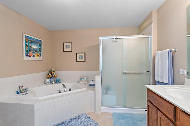 bathroom with tile patterned flooring, vanity, and independent shower and bath