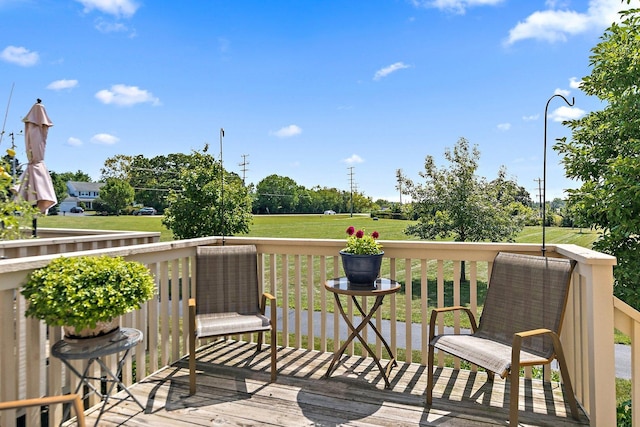 wooden terrace featuring a yard