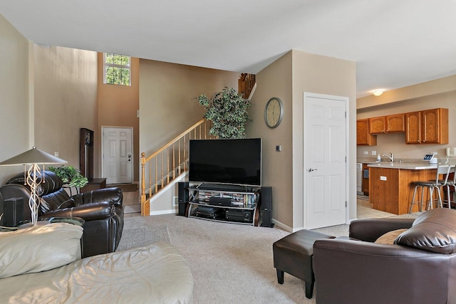 carpeted living room with sink