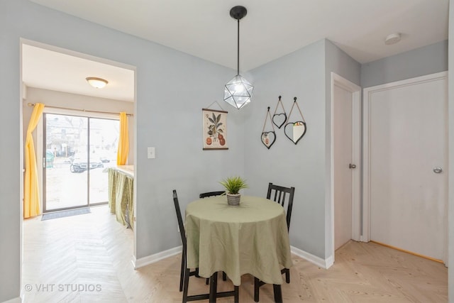 dining space with light parquet floors