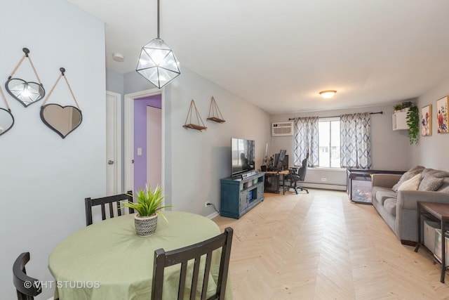 dining room featuring a baseboard radiator, light parquet flooring, and an AC wall unit