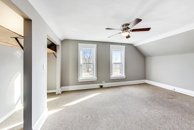 additional living space with lofted ceiling, carpet flooring, and ceiling fan