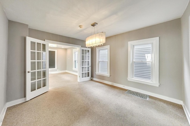 empty room with french doors and plenty of natural light