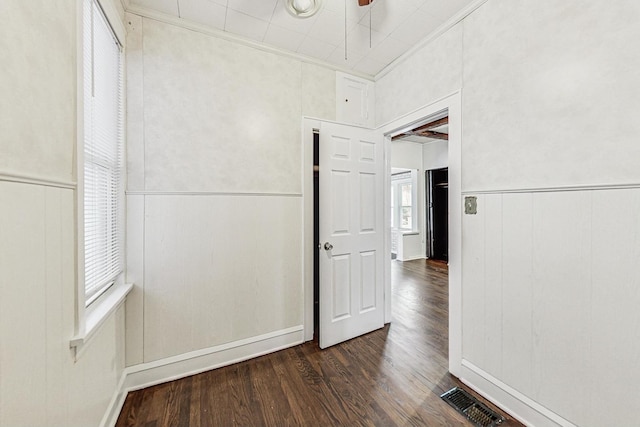 unfurnished bedroom featuring ornamental molding and dark hardwood / wood-style floors