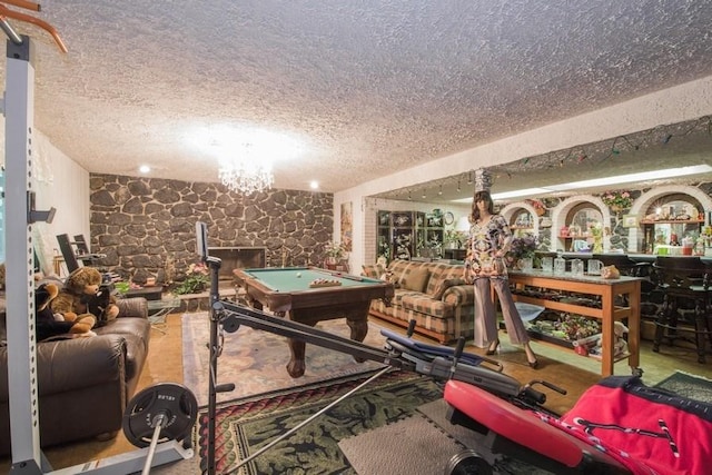 playroom featuring a textured ceiling and billiards