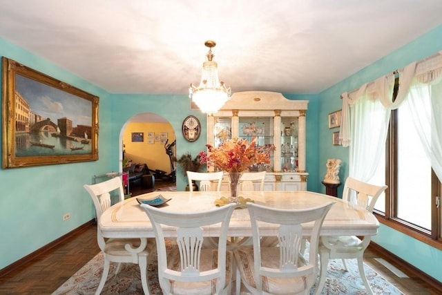 dining space with dark parquet floors