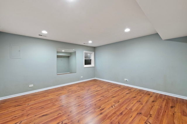 spare room with hardwood / wood-style flooring and electric panel