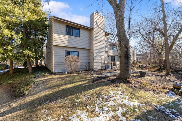 rear view of property featuring central AC unit