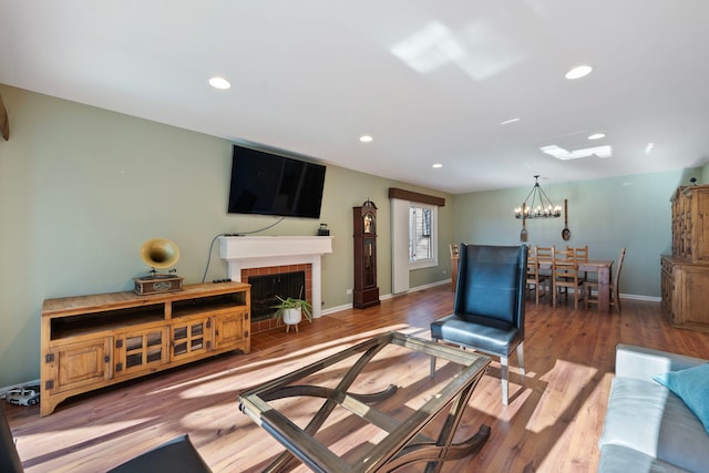 living room with wood-type flooring and a notable chandelier