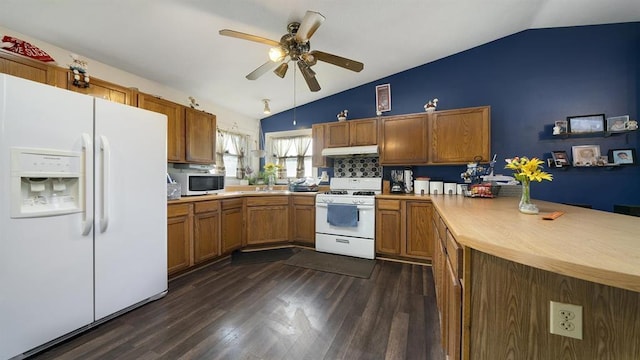 kitchen featuring lofted ceiling, white appliances, dark hardwood / wood-style flooring, and tasteful backsplash