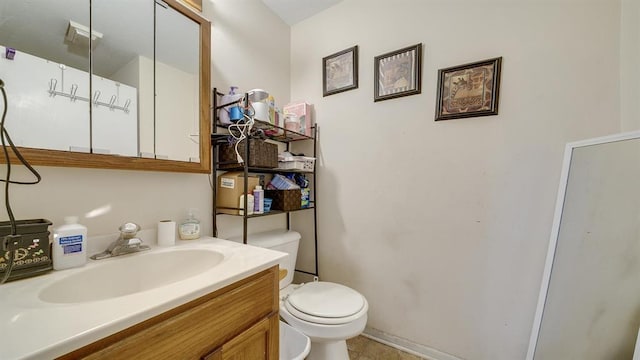 bathroom featuring vanity, tile patterned floors, and toilet