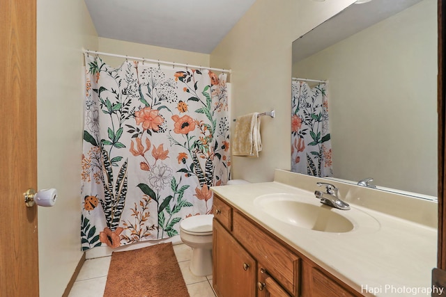 bathroom with tile patterned flooring, vanity, and toilet