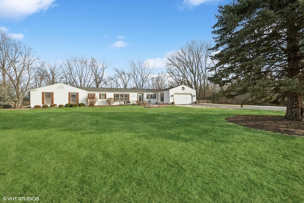 single story home with a garage and a front yard