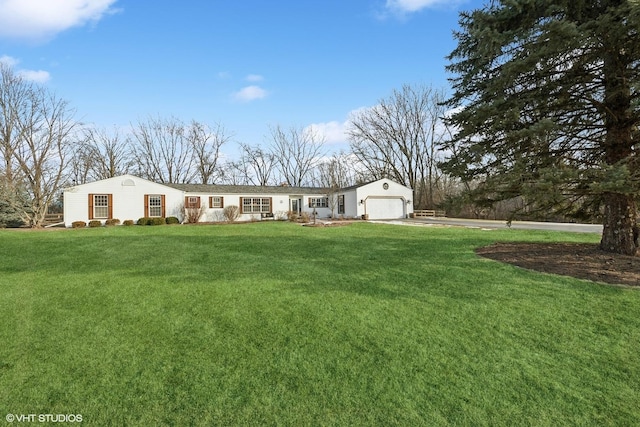 single story home with a garage and a front yard