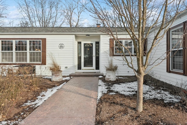 view of snow covered property entrance