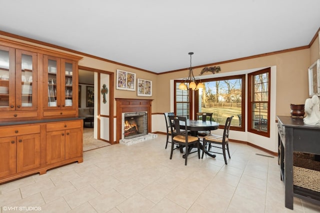 tiled dining area featuring ornamental molding and a chandelier