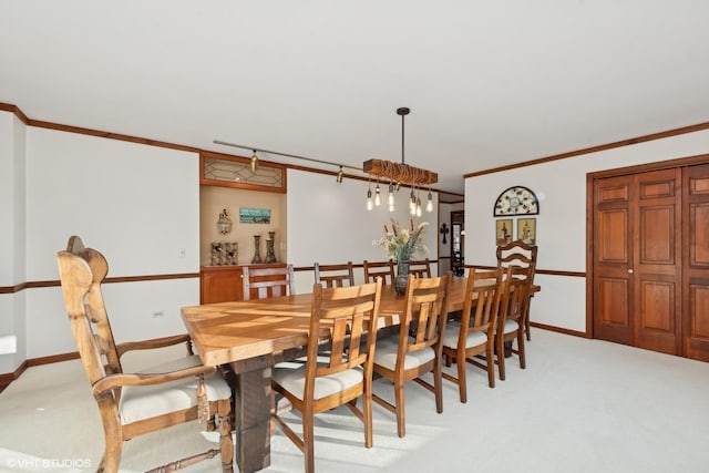 dining area with crown molding and light carpet