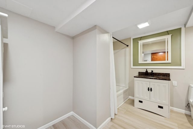 full bathroom with toilet, hardwood / wood-style floors, vanity, and shower / bathing tub combination