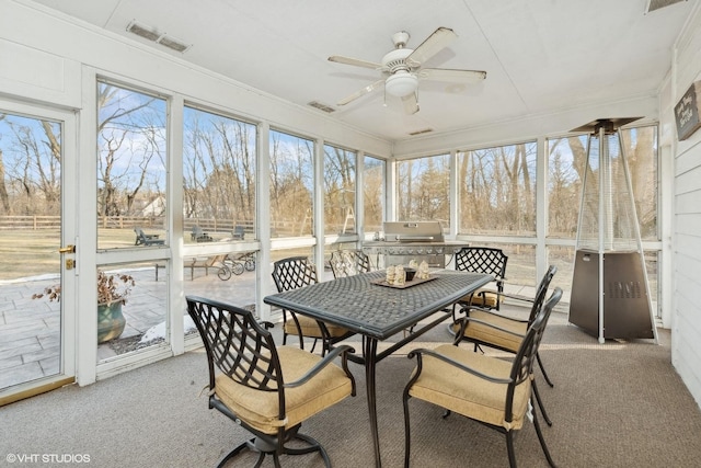 sunroom featuring ceiling fan and a healthy amount of sunlight