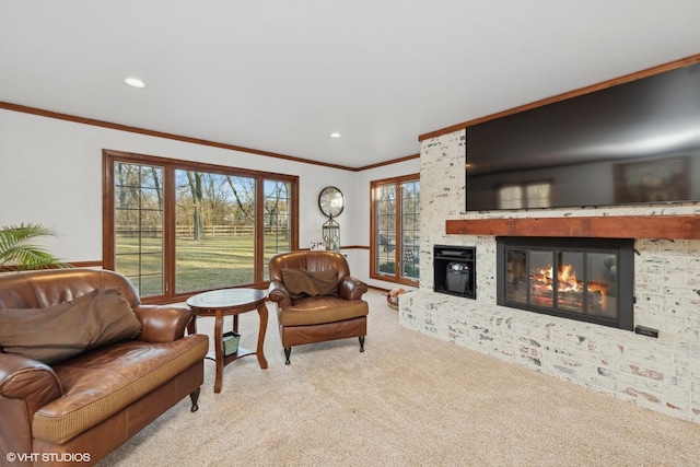 living room with crown molding, a brick fireplace, and light colored carpet