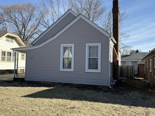 view of side of property with a yard