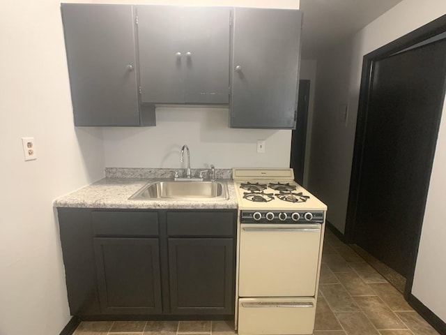 401 Robinson St, Danville, IL 61832 - kitchen featuring white gas range oven and sink