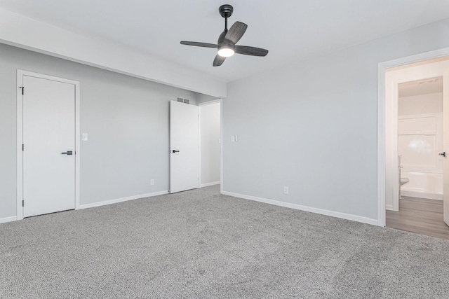 unfurnished bedroom featuring ceiling fan, connected bathroom, and carpet flooring