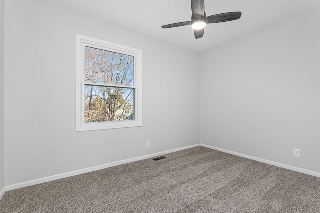 carpeted spare room with ceiling fan