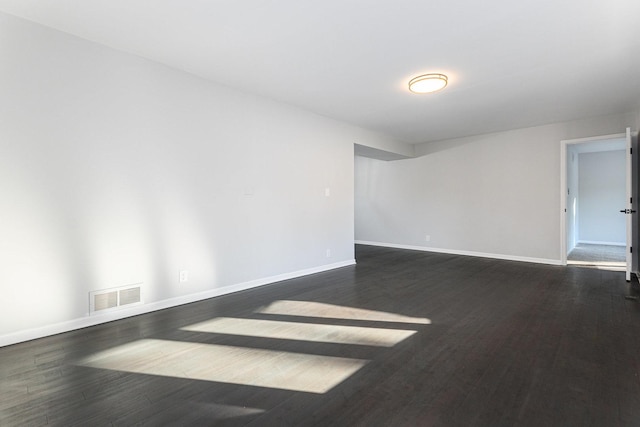 spare room featuring dark hardwood / wood-style flooring