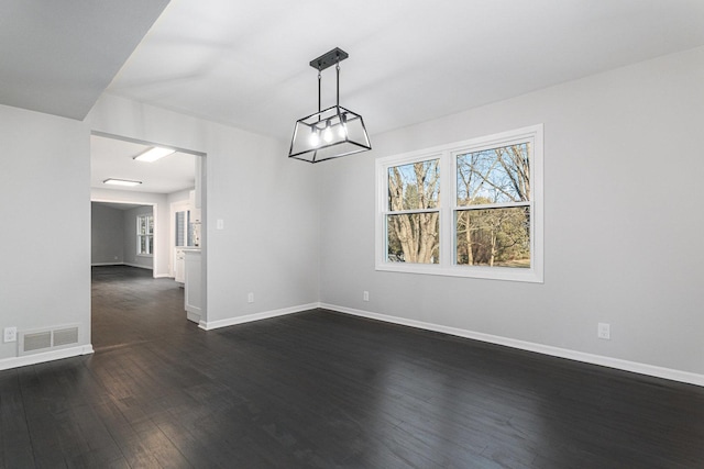 unfurnished dining area featuring dark wood-type flooring