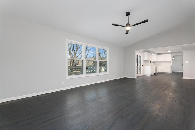 unfurnished living room featuring dark wood-type flooring, ceiling fan, and vaulted ceiling