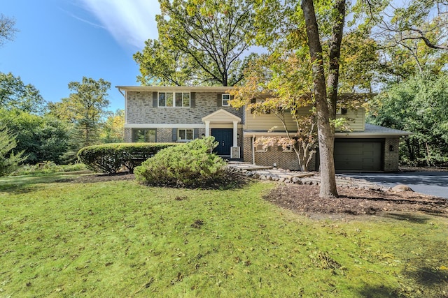 view of front of property featuring a garage and a front lawn