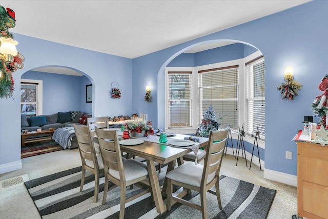 dining room featuring light carpet