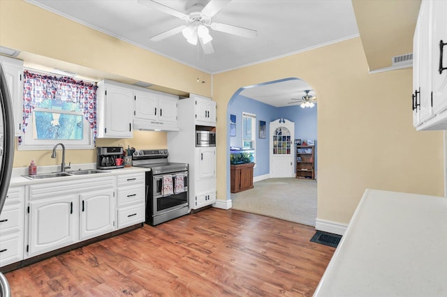 kitchen featuring sink, appliances with stainless steel finishes, dark hardwood / wood-style flooring, ceiling fan, and white cabinets